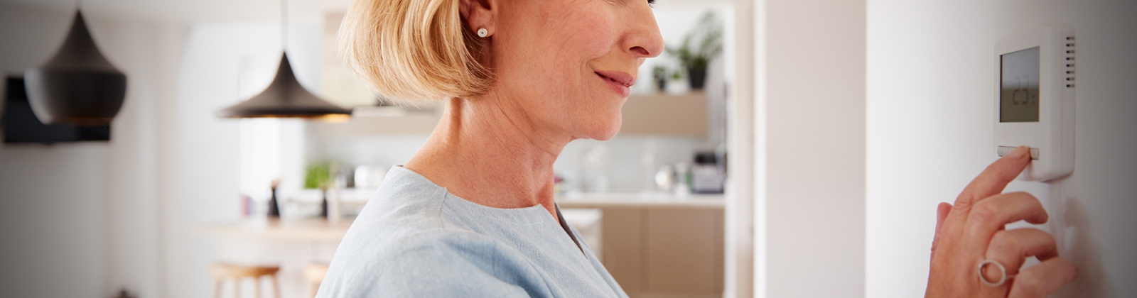 woman setting thermostat