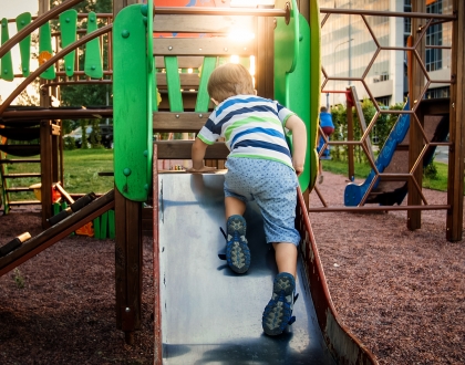 boy on playground slide