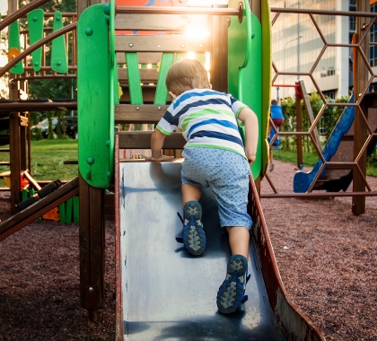 boy on playground slide