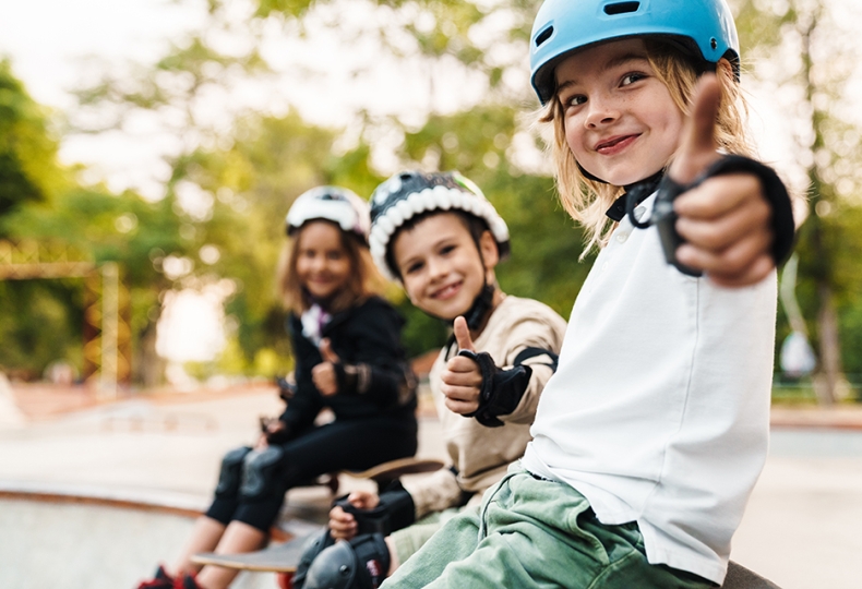 Kids on bikes giving thumbs up